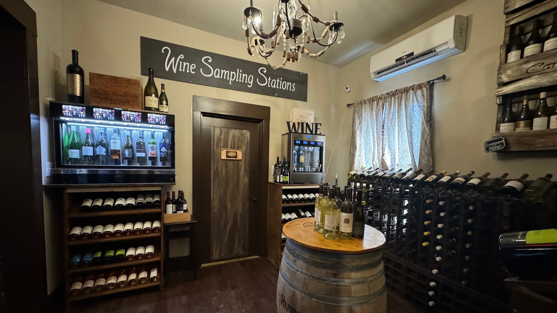 interior area of a wine bar with a wine dispenser and shelves filled with wine